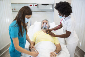 Female Respiratory Therapists taking care of a patient
