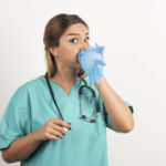 Respiratory Therapist closing her nose